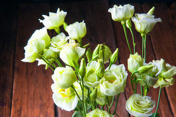 White rose bouquet on wooden background