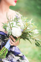 beautiful young woman with a bouquet of flowers in their hands