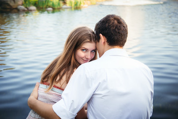 Fototapeta premium Portrait of a beautiful young woman in love woman hugging man