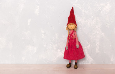 toy red doll girl on the wooden floor