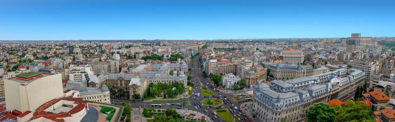 Fototapeta na wymiar 180 Degrees aerial panorama of the capital city of Romania, Bucharest. Blue sky above the center of the city.