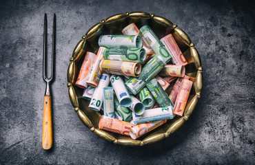 Euro money euro banknotes in bronze bowl.