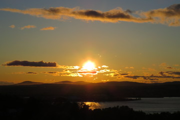 Luminous sunset with clouds above the city of Levis, Quebec, Canada.