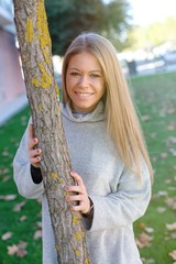 Pretty blonde girl at autumn