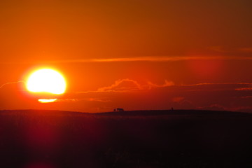 Bright sunset over a dark field of Saskatchewan, Canada.