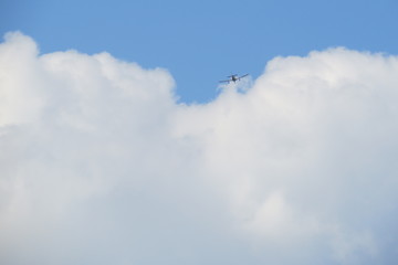 Small airplane passing in a fluffy cloud.