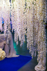 beautiful wedding decor of white flowers in the restaurant