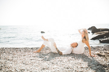 Happy romantic fashion couple in love have fun on beautiful sea at summer day