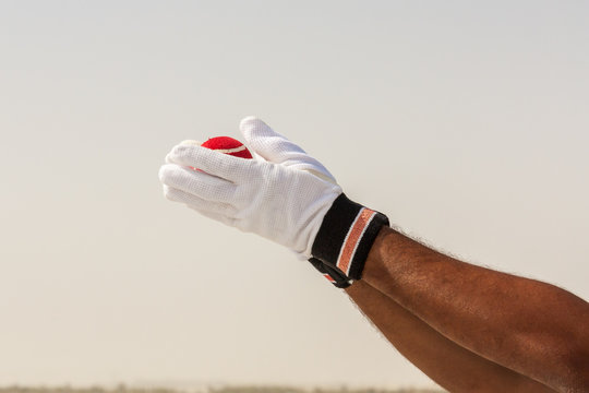 Taking the catch of red ball with hands