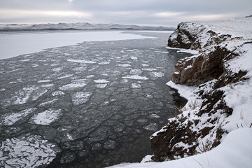 Winter landscape, drifting ice floes surrounded by rocks © Aniland