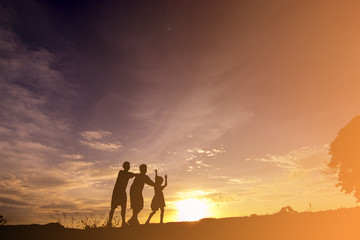 Fototapeta na wymiar silhouette of a happy family and happy time sunset 
