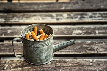 Cigarette butts discarded in old pots