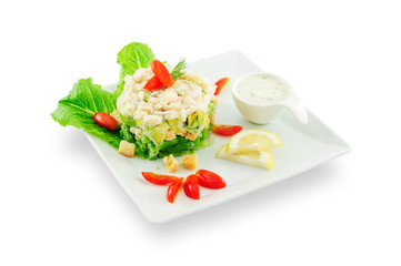 Crab salad with avocado and French beans on white plate isolated