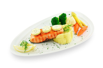 Salmon steak with mashed potato and vegetables on white plate isolated