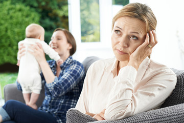 Sad Mature Woman Jealous Of Mother With Young Baby