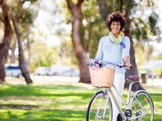 Fototapeta na wymiar Happy young woman with bicycle