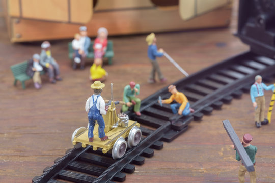 Construction toy / View of construction site of mini toy worker on wood background.
