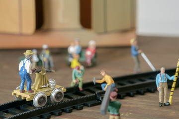 Obraz premium Construction toy / View of construction site of mini toy worker on wood background.