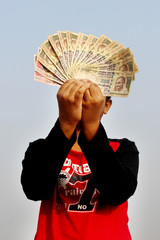 9th November, 2016, India- A unidentified boy took some Indian currency in the air. Now these currencies are invalid. Waiting for rebirth.