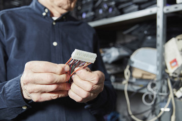Man holding motherboard connector