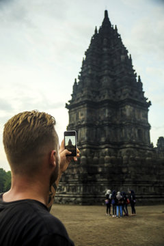 Indonesia, Java, Tourist photographing Prambanan temple