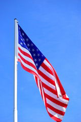 The American flag waving in blue sky