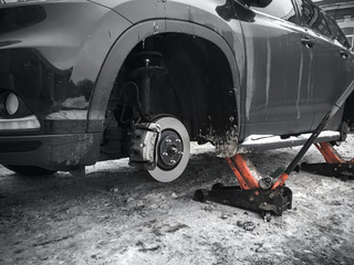 Replacing wheels on new black SUV car © evannovostro