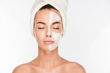 Young beautiful woman with facial mask - Powered by Adobe