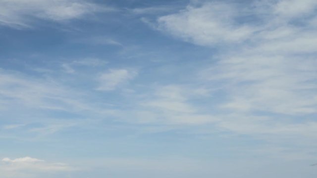 Airplane landing on island Bali airport under blue sea with waves on the horizon. Cinematic shot of overhead flying aircraft with beautiful ocean on cloudy sky background. Focal length 50 mm