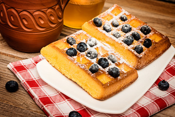 Belgium waffles with blueberries  on white plate