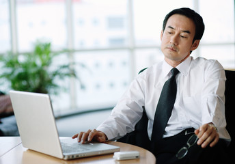 Businessman in office using laptop