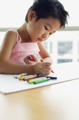 Young girl with crayons, drawing