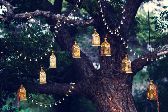 Night wedding ceremony with a lot of candles and vintage lamps o