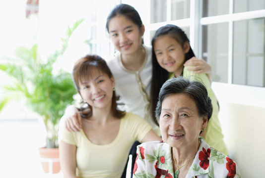 Three generations of females, looking at camera