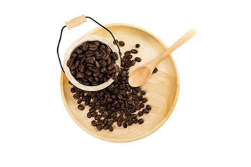 Coffee beans on the wooden plate and tank with spoon, isolated and separate clipping path