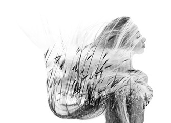 Monochrome double exposure of happy girl dancing and wheat field