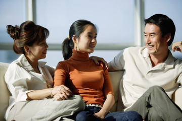 Family sitting on sofa