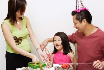Family with one child celebrating a birthday