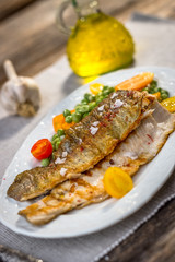 Grilled fish fillets  with   vegetables on plate