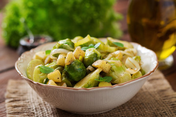 Stewed Brussels cabbage sprouts, apples and leeks in bowl. Dietary menu.