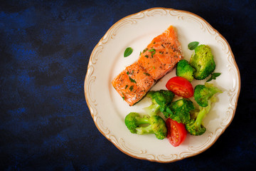 Baked fish salmon garnished with broccoli and tomato. Dietary menu. Fish menu. Seafood - salmon. Top view