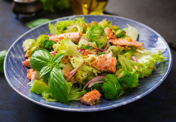 Salad of stewed fish salmon, broccoli, lettuce and dressing. Fish menu. Dietary menu. Seafood - salmon.