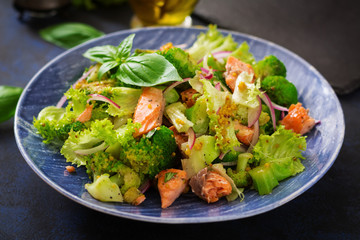 Salad of stewed fish salmon, broccoli, lettuce and dressing. Fish menu. Dietary menu. Seafood -...