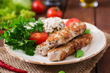 Minced Lula kebab grilled turkey (chicken) with rice and tomato.