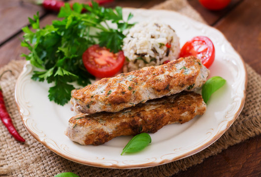 Minced Lula kebab grilled turkey (chicken) with rice and tomato.