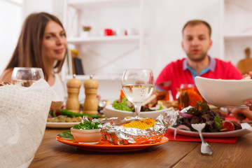 Served table at dinner party, people unfocused