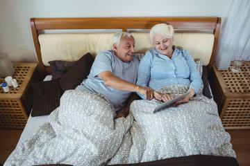 Senior couple using digital tablet
