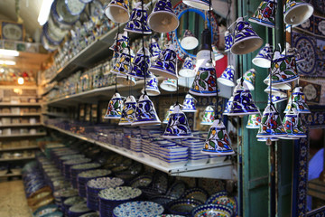 Fototapeta na wymiar Ceramic plates and other souvenirs for sale located on Arab baazar inside the walls of the Old City of Jerusalem