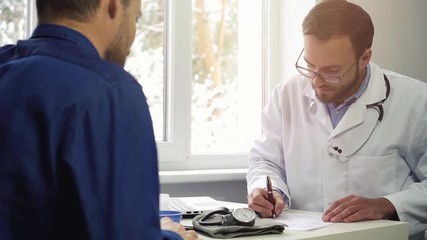 doctor visit - writing prescription for patient - Powered by Adobe