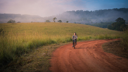 Obraz premium women riding bike in the park morning